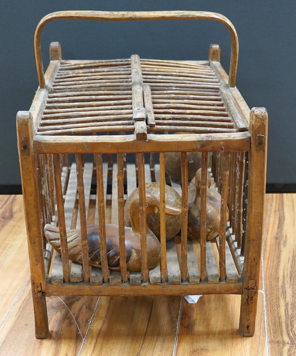 A large wooden chicken carrier with two carved ducks and two balls, chicken carrier 42cm high, 39cm wide, 53cm long